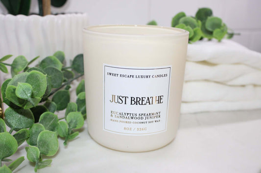 ust Breathe candle by Sweet Escape Luxury Candles, featuring a soothing blend of marine, spearmint, eucalyptus, sea salt, juniper, sandalwood, and fresh thyme. Infused with essential oils, perfect for a relaxing home spa experience